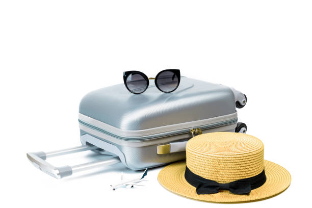 istock Suitcase, sunglasses with toy plane and straw hat in travel composition isolated on white background. Design of summer vacation holiday concept. 1315516537