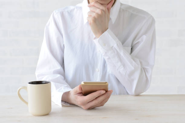 Thinking woman while watching smart phone Thinking woman while watching smart phone information overload photos stock pictures, royalty-free photos & images