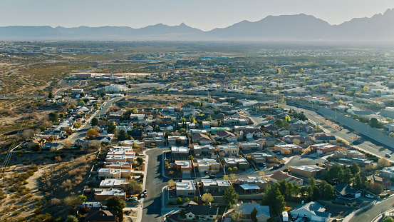 Aerial view of tract housing developments in the city of Las Cruces, New Mexico at sunset.