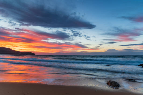 istock Sunrise at the seaside with pastel coloured clouds 1315526383