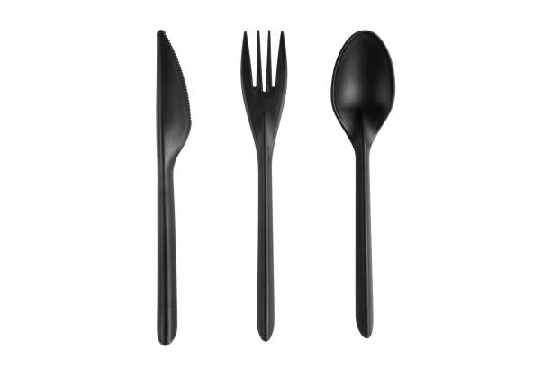 istock Black plastic spoon, knife and fork isolated on white background. Disposable tableware set isolated with clipping path. 1315543098