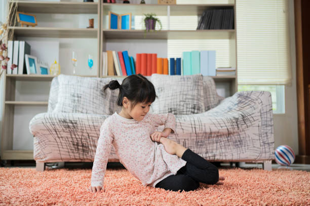 Cute little girl practicing yoga on the carpet