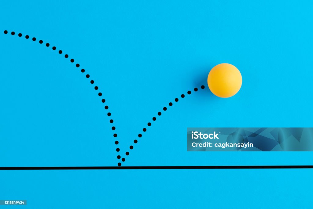 Bouncing table tennis ball is on blue background. Table tennis ball is bouncing on blue background. Bouncing Stock Photo