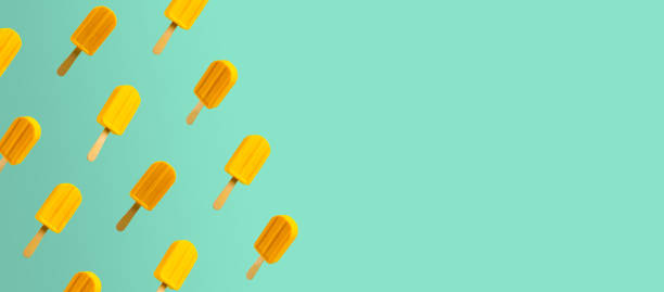 Yellow popsicles on abstract turquoise background with empty space