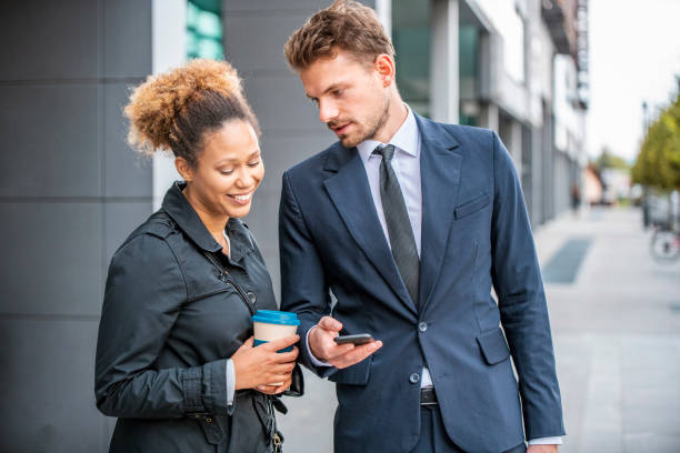istock Business Associates Checking Smart Phone on Coffee Break 1315556000