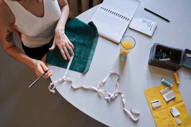 istock Woman making a pattern with a pencil and measuring type while sitting at the table 1315566244