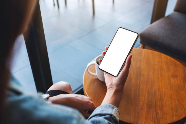 istock a woman holding mobile phone with blank white desktop screen 1315570835
