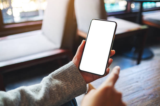 istock a woman holding mobile phone with blank white desktop screen 1315570894