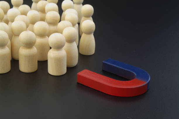 istock Magnet attracting crowd of people (wooden figures). 1315572192