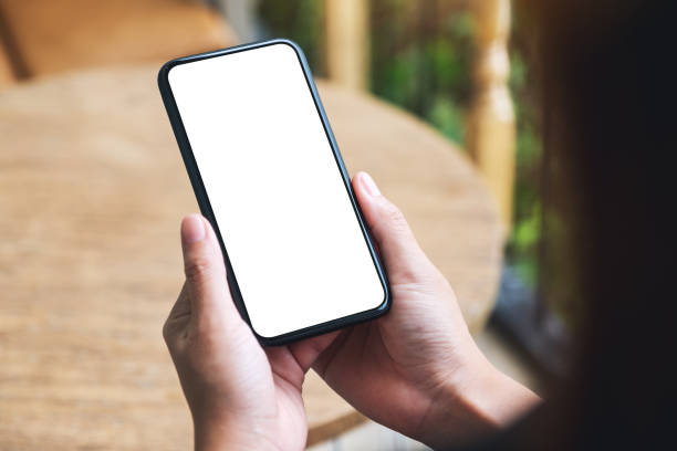 istock a woman holding mobile phone with blank white desktop screen 1315575669