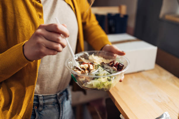 istock Anonymous Woman Eating a Take Out Meal 1315583130