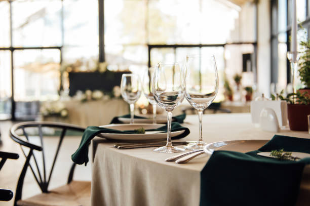 istock Luxurious restaurant. Luxurious interior, white tables, serving dishes and glasses for guests 1315584920