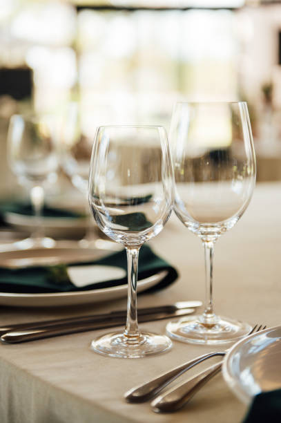 istock Luxurious restaurant. Luxurious interior, white tables, serving dishes and glasses for guests 1315584944