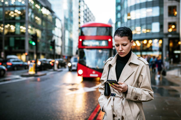 istock Commuter in London using mobile phone while waiting for bus 1315588554