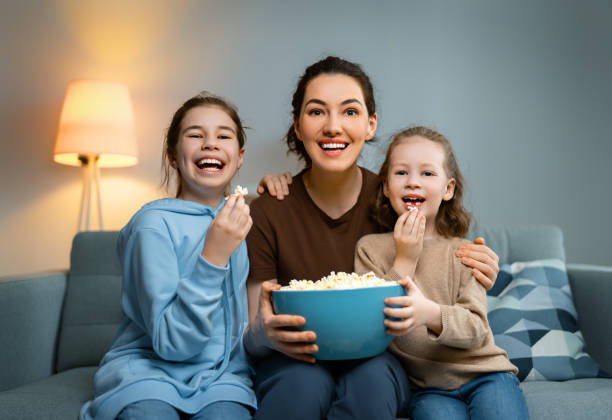 istock family watching TV 1315593328