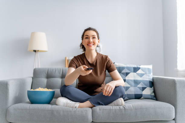 istock woman watching TV 1315593332
