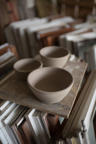 istock Pottery workshop with several handthrown pots on a wooden board 1315598067