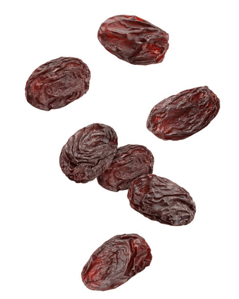 Falling raisin isolated on white background, clipping path, full depth of field stock photo
