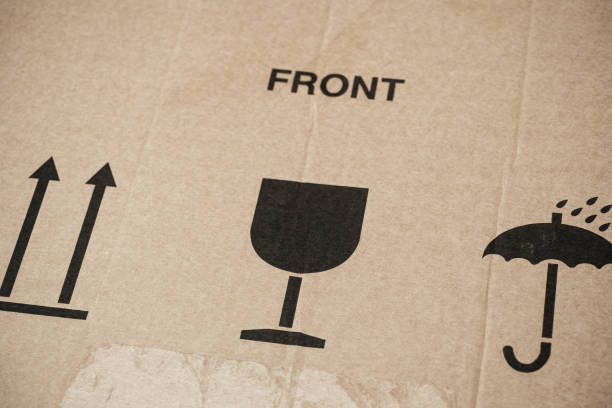 istock Word Front and three symbols on cardboard box - This Way Up, Keep Dry and Fragile for careful transportation. 1315601416