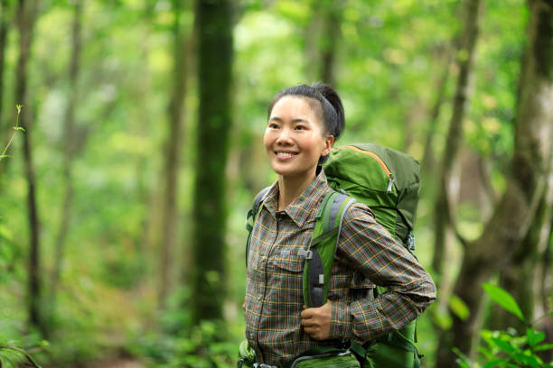 istock Woman backpacker hiking in spring forest 1315602187