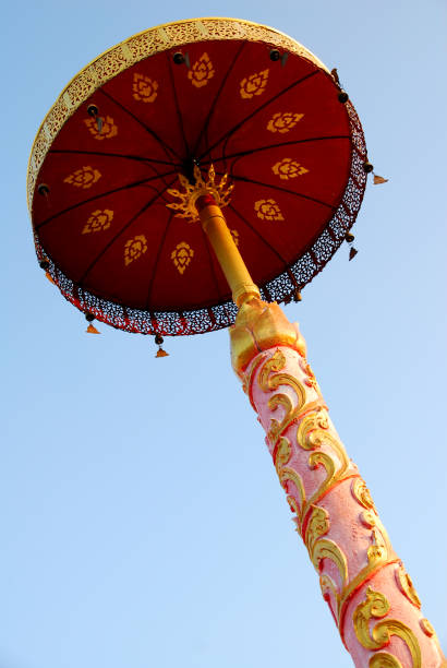 istock Golden Buddha umbrella and blue sky texture background 1315606192