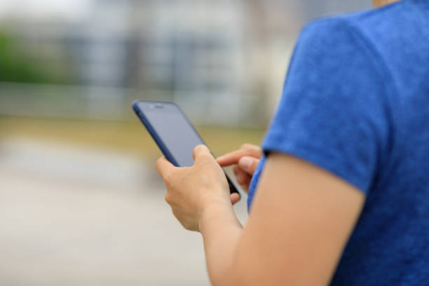 istock Asian woman using smartphone outdoors 1315608269