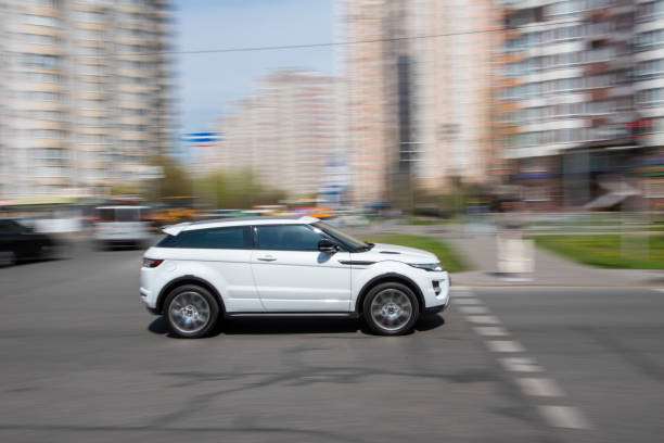 White Land Rover Range Rover Evoque car moving on the street. Ukraine, Kyiv - 20 April 2021: White Land Rover Range Rover Evoque car moving on the street. Editorial evoque stock pictures, royalty-free photos & images