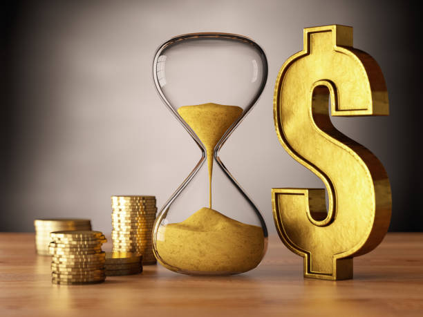 istock Dollar Sign with Hourglass Next to Coins 1315613117