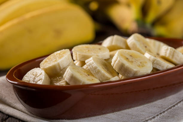 istock Bunch of bananas with sliced ​​bananas on the table 1315613651