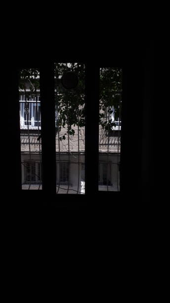 istock Dark room and bright window.  Black blank area 1315613843