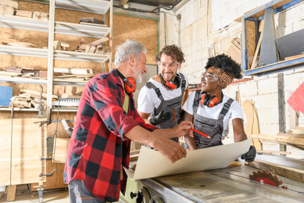 istock A Group of Multicultural Carpenters is Looking at the Paper Projects in a Workshop. 1315616908