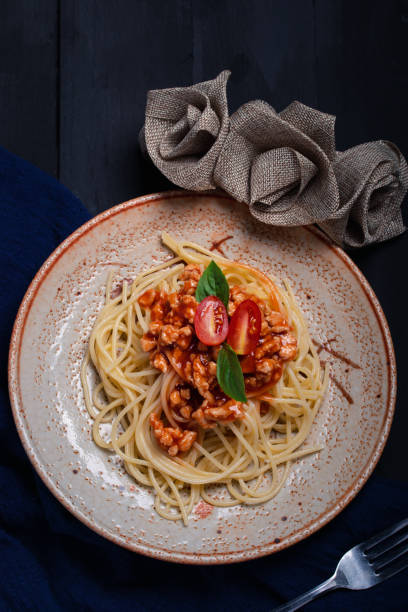 istock Fried spaghetti with chicken sauce in black background plate 1315620513