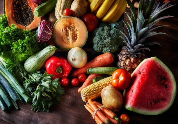 istock Assortment of tropical fruits and vegetables on a table in a rustic kitchen. Natural lighting 1315623849