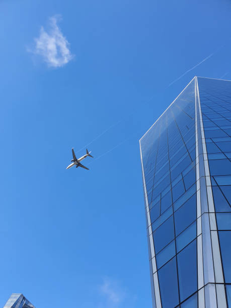 Airplane, sky and skyscrapers Airplane flying, sky and skyscrapers real estate outdoors vertical usa stock pictures, royalty-free photos & images