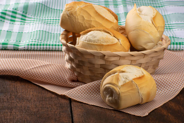 istock breads in a basket on checkered tablecloth over rustic wood, black background, selective focus. 1315630767