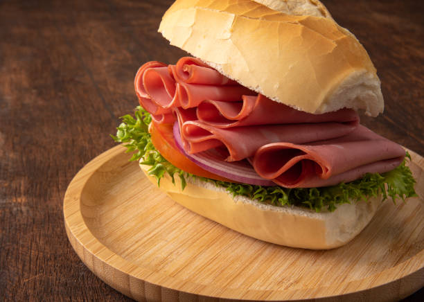istock mortadella sandwiches placed on a wooden plate over rustic wood, selective focus. 1315631019