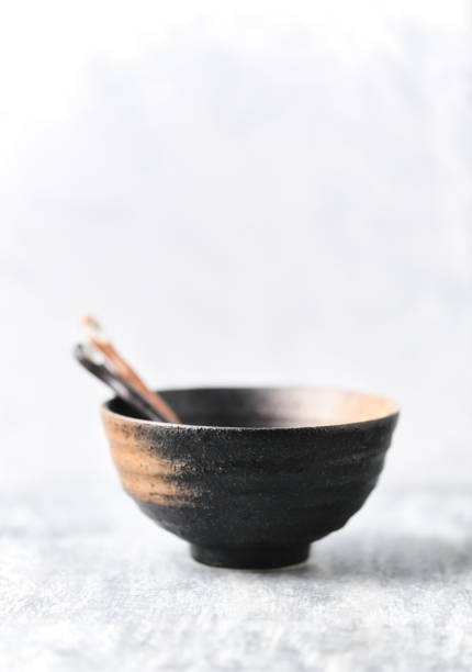 istock Traditional ceramic bowl on bright wooden background. Copy space. 1315635726