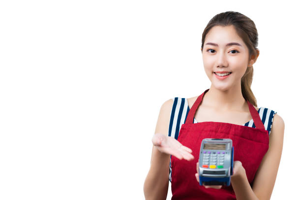 barista asian female wear uniform apron hand hold credit card reader machine ready to smart money payment smile and cheerful welcome for service isoalate white background barista asian female wear uniform apron hand hold credit card reader machine ready to smart money payment smile and cheerful welcome for service isoalate white background asian cashier stock pictures, royalty-free photos & images