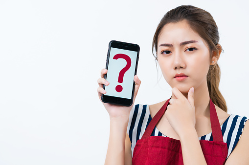 coffeeshop restaurant business owner wear apron hand hold smartphone show questionmark sign with wonder curious facial expression  business problem and solution ideas concept isolate white background