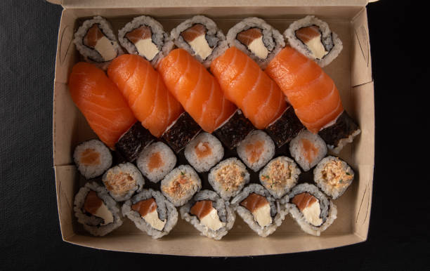 istock Sushi, sushi delivery box in Brazil, black background, selective focus. 1315636038