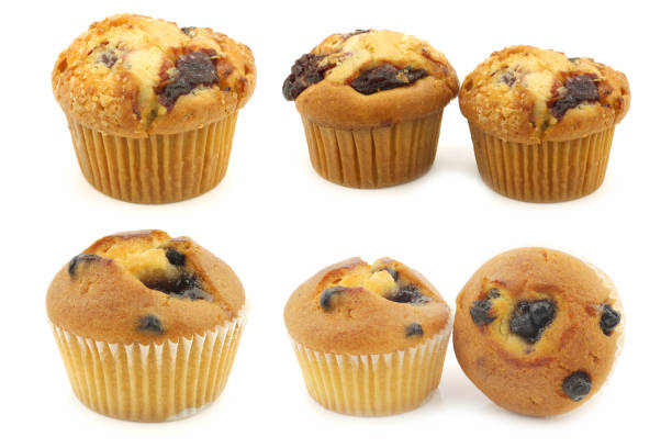 freshly baked blueberry and cherry  muffins on a white background