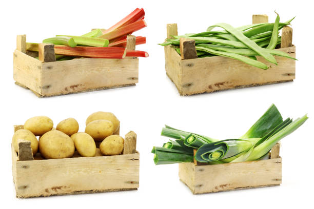 Fresh cooking vegetables in a wooden crate on a white background