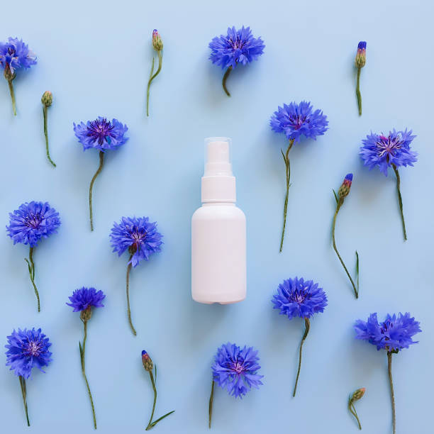 istock White plastic spray bottle mockup and blue flowers on blue background. Natural organic spa cosmetics and liquid antimicrobial spray concept. Square flatlay. Top view, template, bottle for branding 1315641241
