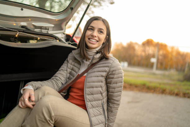 istock Beautiful woman in open car trunk 1315644695