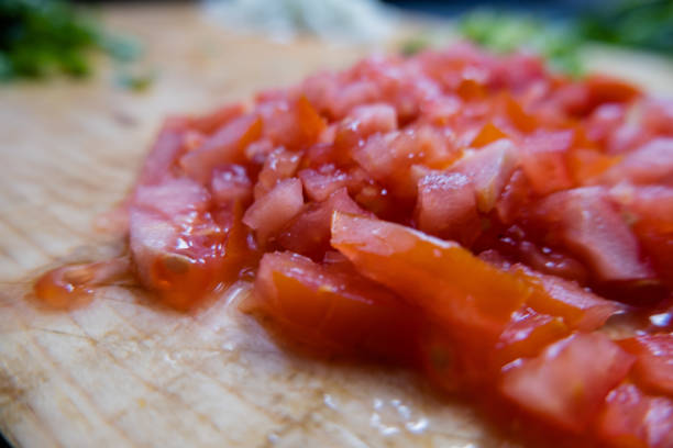istock Close-up of fresh tomato slices on a cutting table 1315648588
