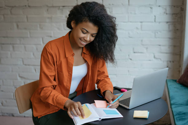 istock confident businesswoman working start up project, taking notes using scrum for productivity. Portrait of happy woman freelancer sitting at workplace. Successful business 1315650807