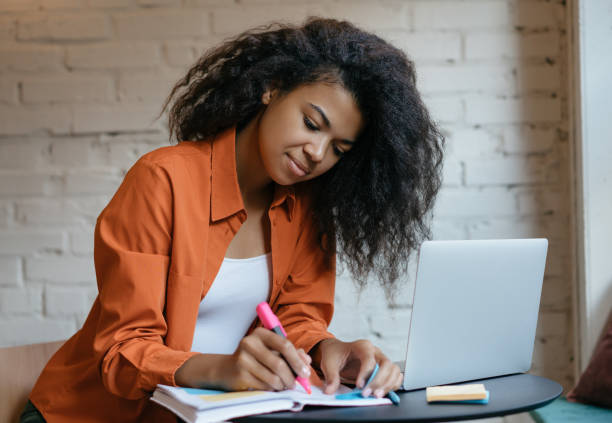 istock Attractive African American woman freelancer taking notes working at home 1315650882