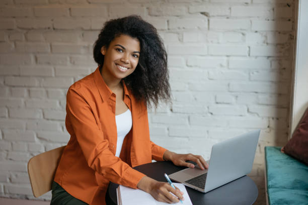 istock Businesswoman using laptop computer, taking notes, planning start up. Successful freelancer working at home 1315650883