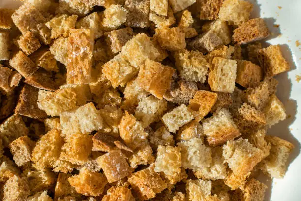 Fried bread crumbs with salt under sunlight on table