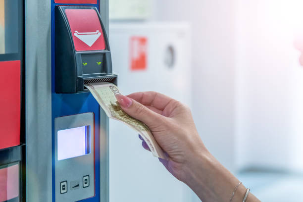 istock Woman inserts a 100 ruble banknote into a currency validator 1315652210